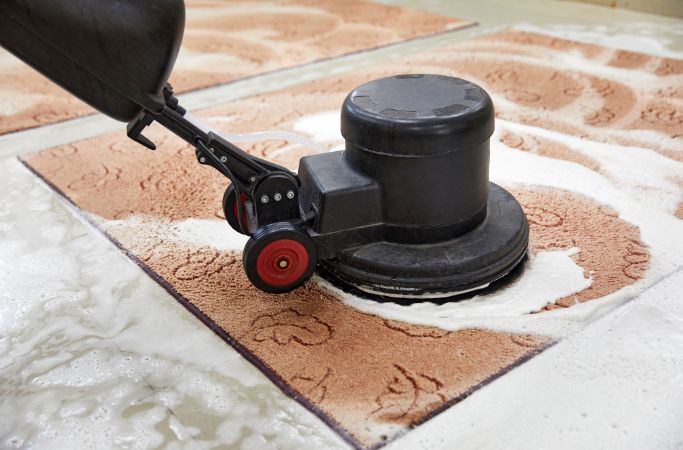 A Queen City Cleaners professional performing deep cleaning with specialized tools, focusing on removing hidden dirt and grime for a refreshed, spotless space.